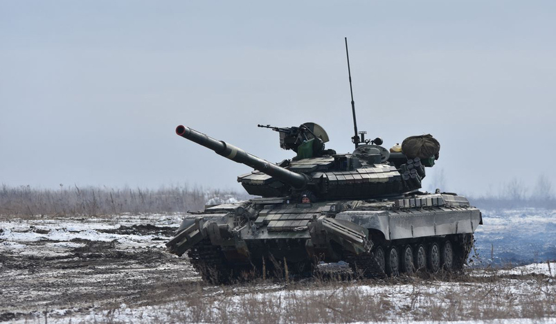 Ukrainian servicemen drive a tank during drills